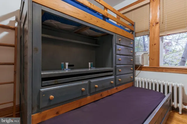 a view of a room that has a bed and a window