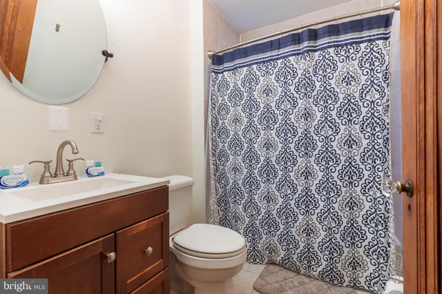 a bathroom with a sink toilet and a mirror