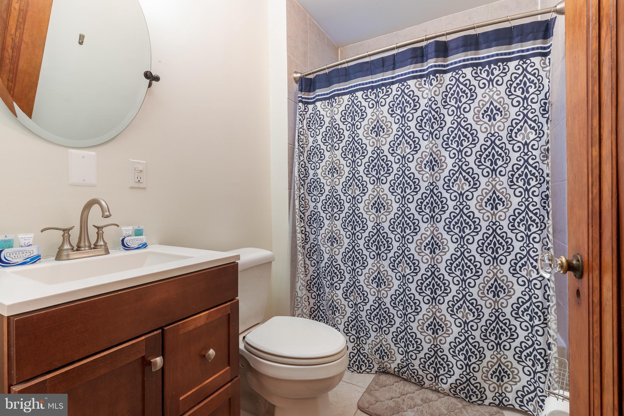 3817 22nd Street Northeast Washington, DC 20018 - Photo 28 of 37 a bathroom with a sink toilet and a mirror