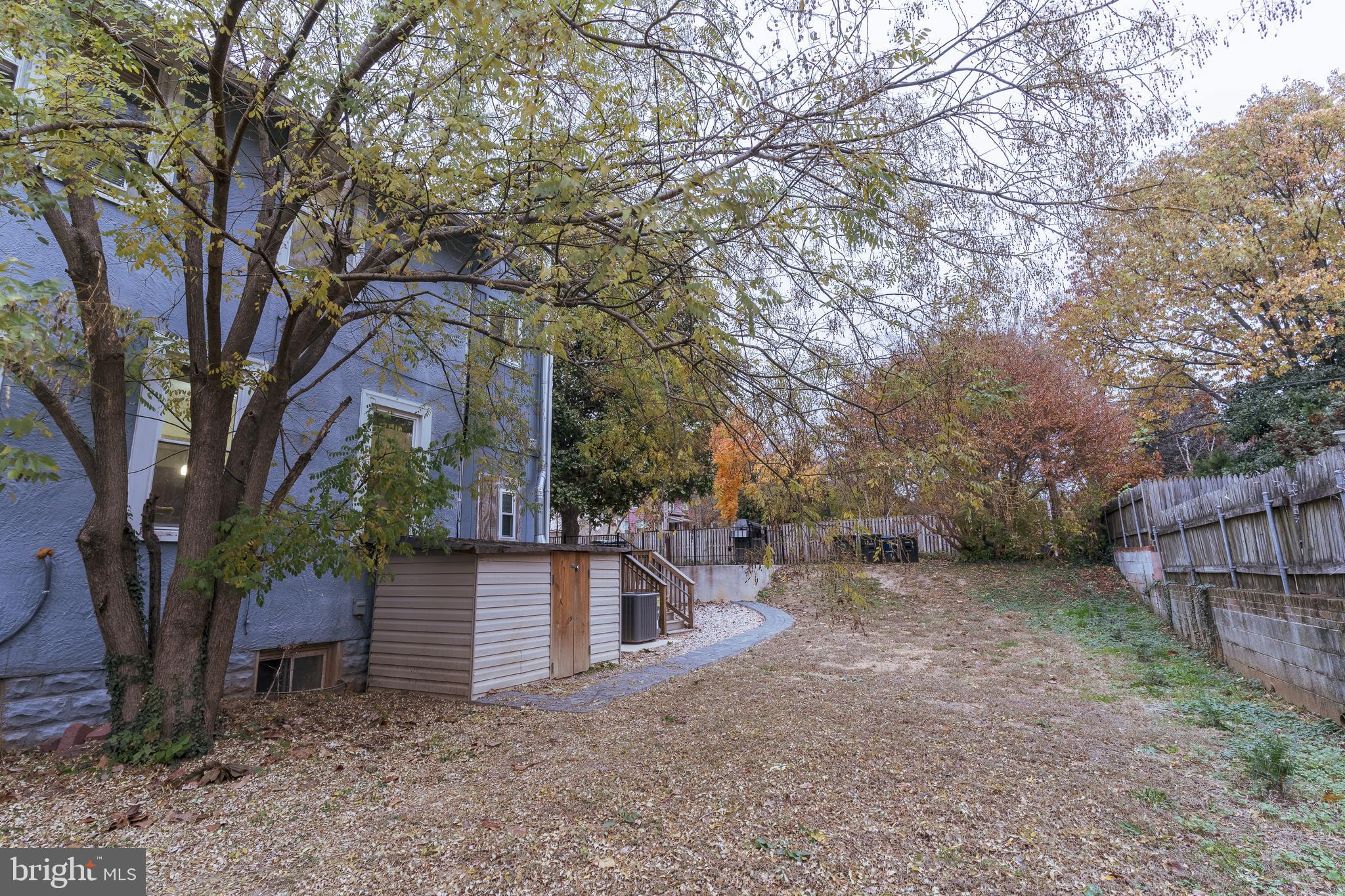 3817 22nd Street Northeast Washington, DC 20018 - Photo 32 of 37 a view of a house with a large tree and wooden fence