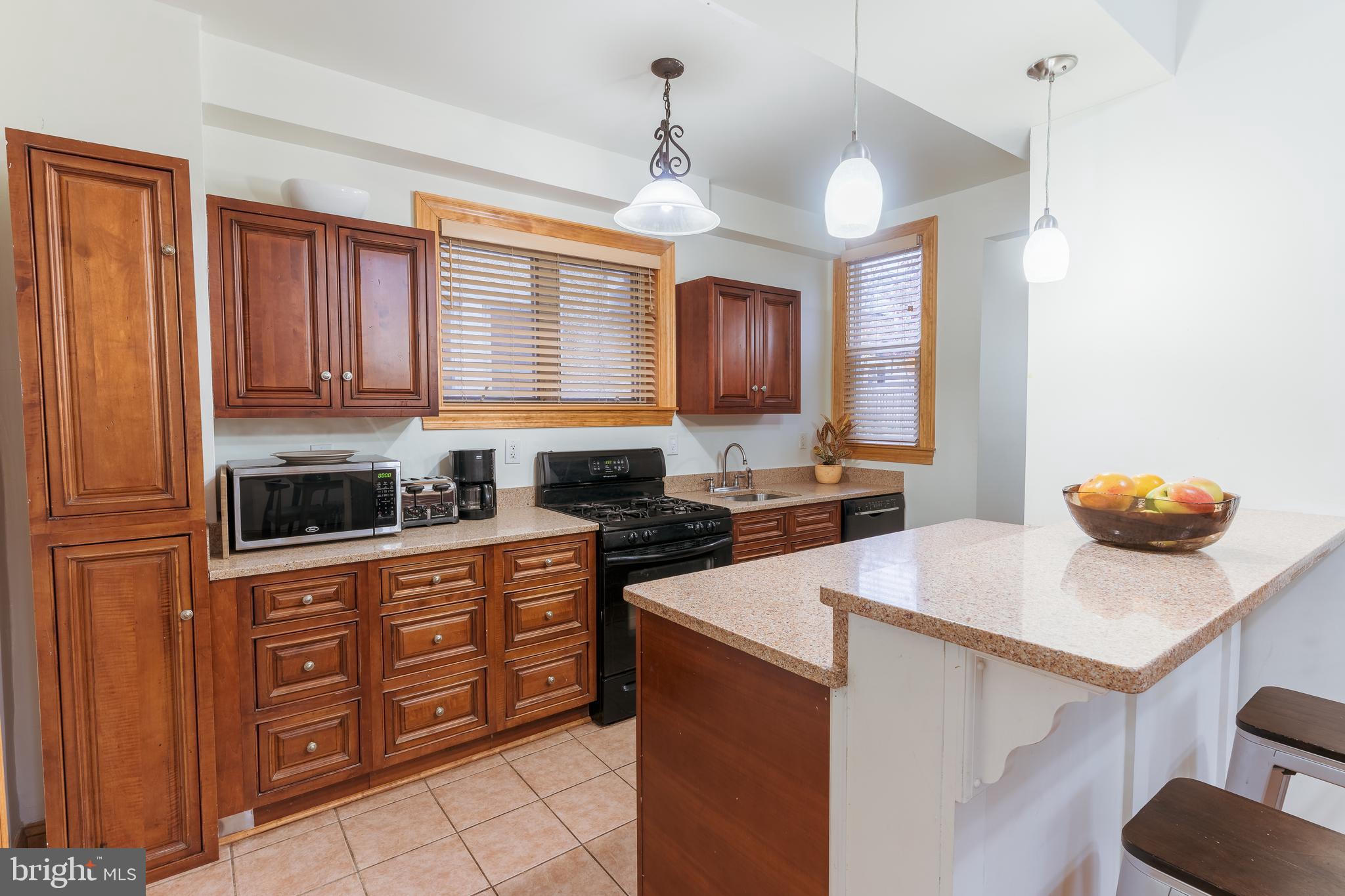 3817 22nd Street Northeast Washington, DC 20018 - Photo 7 of 37 a kitchen with stainless steel appliances granite countertop a sink dishwasher stove top oven and cabinets with wooden floor