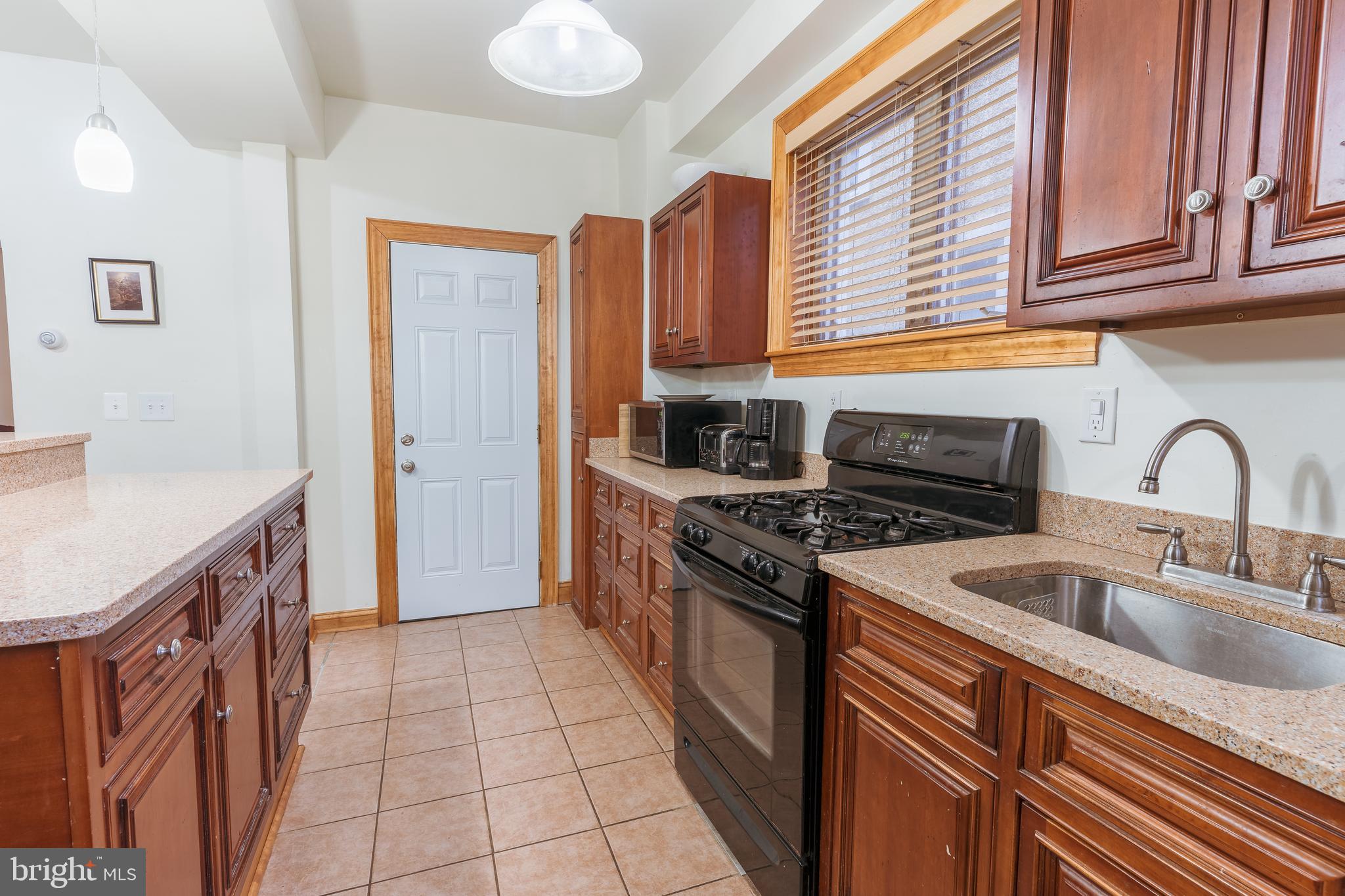 3817 22nd Street Northeast Washington, DC 20018 - Photo 9 of 37 a kitchen with stainless steel appliances granite countertop a sink stove and refrigerator