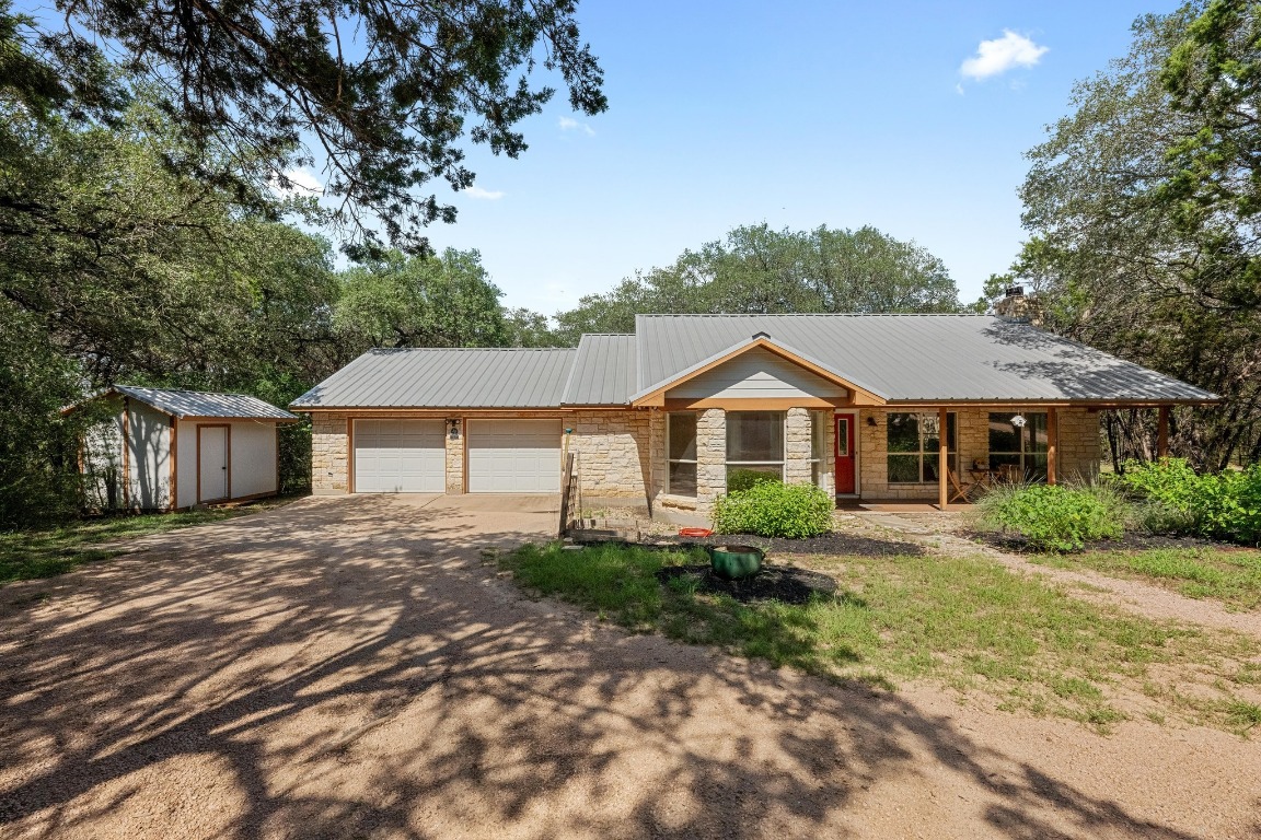 a front view of a house with a yard and trees