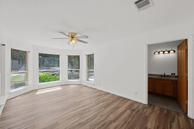 wooden floor in an empty room with a window