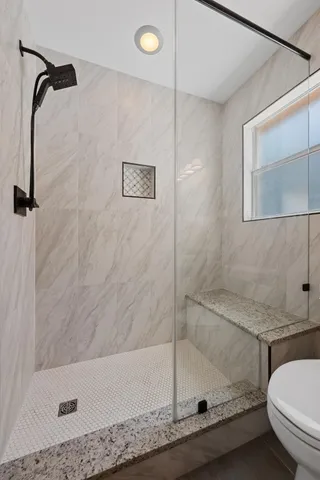 a bathroom with a granite countertop sink a toilet and bathtub