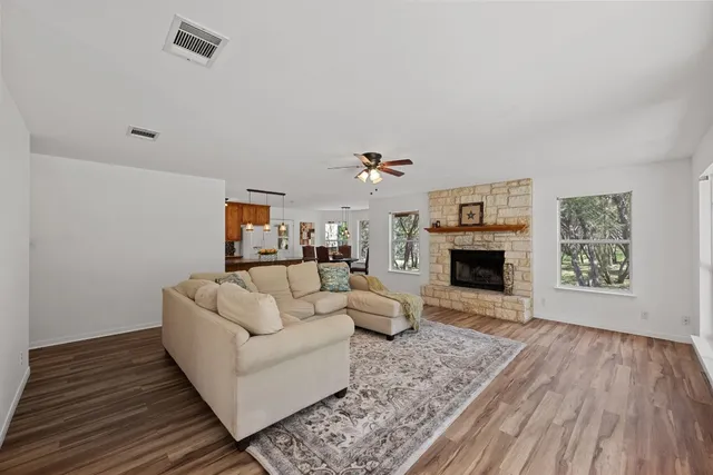 a living room with furniture a fireplace and a table