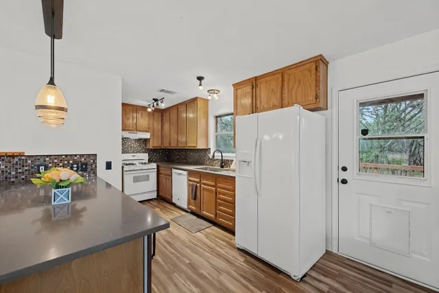 a kitchen with stainless steel appliances a refrigerator sink and stove