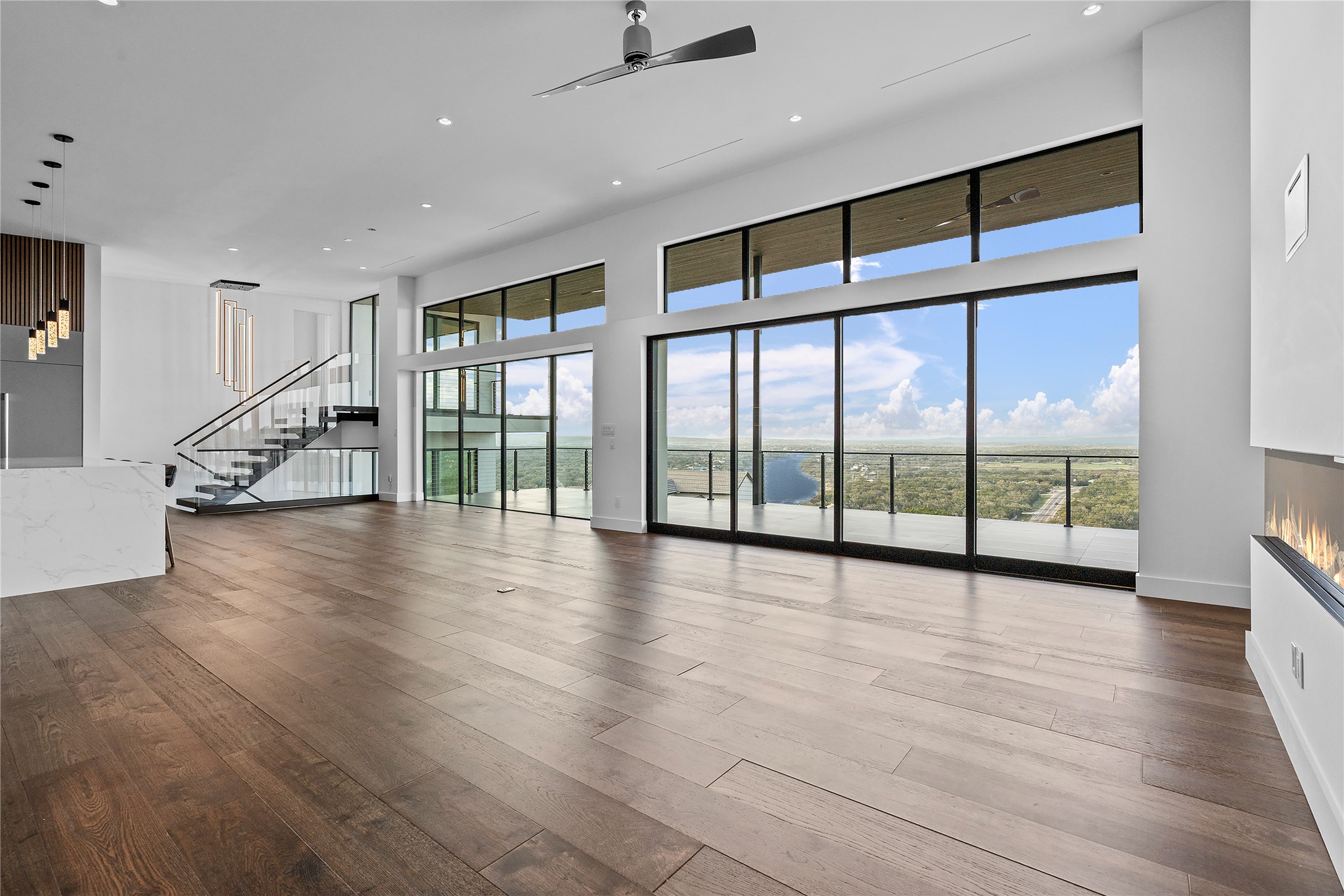 1702 Moonlight Trace Spicewood, TX 78669 - Photo 10 of 40 Unfurnished living room with recessed lighting, ceiling fan, dark wood-type flooring, and a high ceiling
