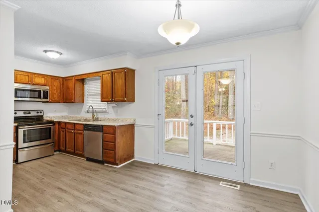 a large kitchen with stainless steel appliances granite countertop a stove a sink and a refrigerator