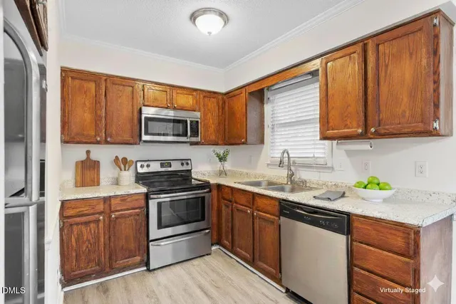 a kitchen with stainless steel appliances granite countertop a sink stove and microwave