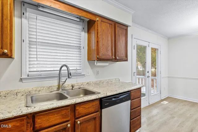 a kitchen with stainless steel appliances granite countertop a sink and a window