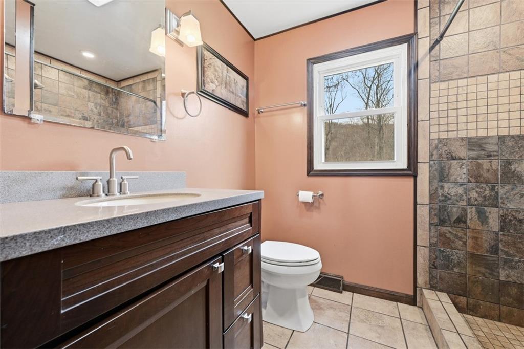192 Yellow Creek Road Harmony, PA 16037 - Photo 16 of 41 a bathroom with a granite countertop sink and a toilet