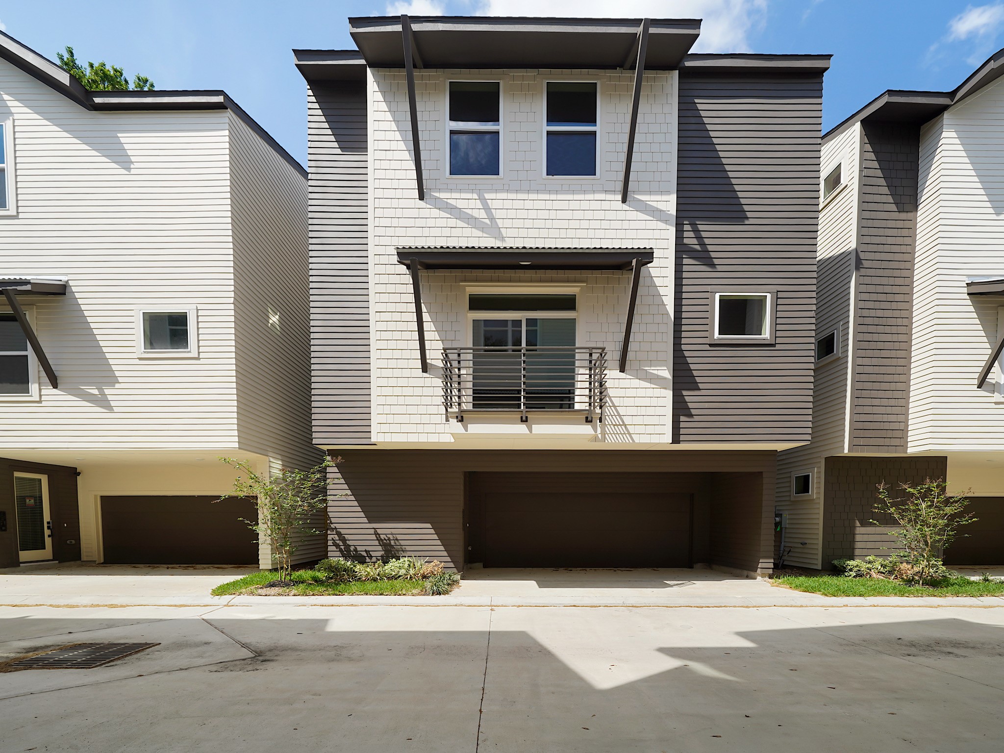 861 Rachel Street, Unit E Houston, TX 77091 - Photo 1 of 29 Discover modern living in this stylish three-story townhouse, featuring a striking mix of light and dark siding, a charming balcony, and a convenient double garage, all nestled within a meticulously maintained complex.