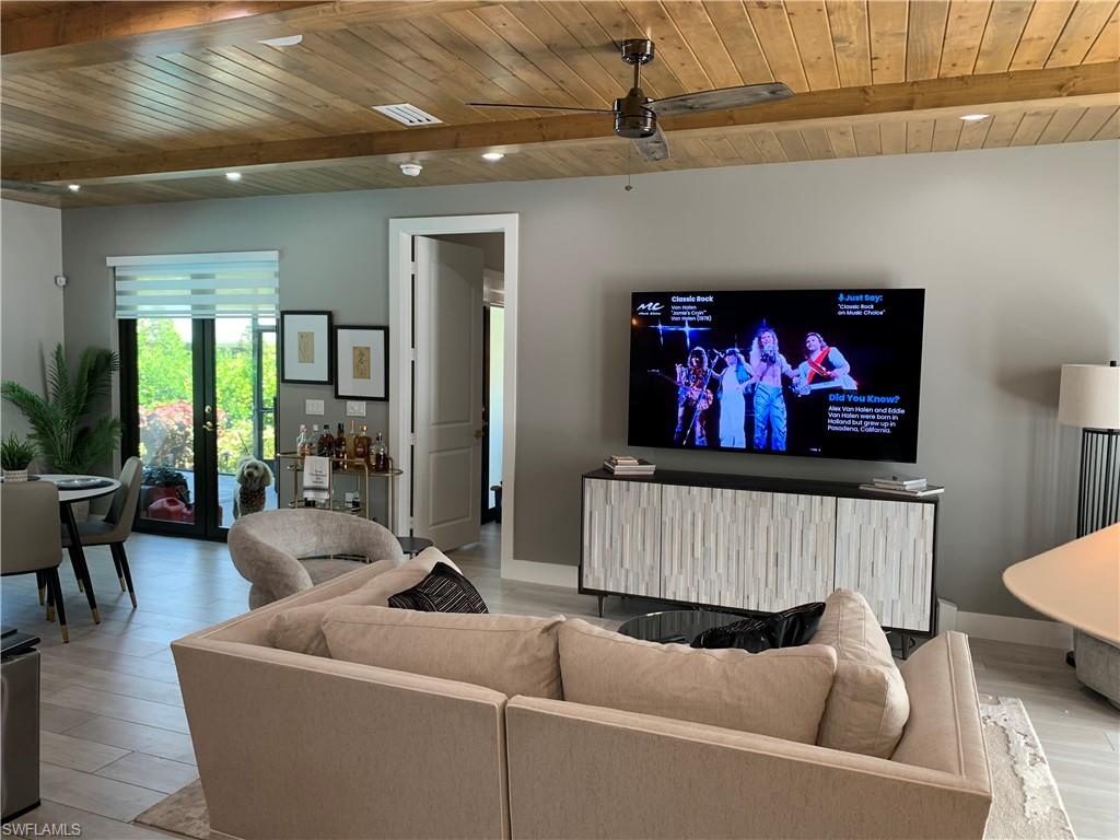 3651 29th Avenue Southwest Naples, FL 34117 - Photo 18 of 49 a living room with furniture and a flat screen tv