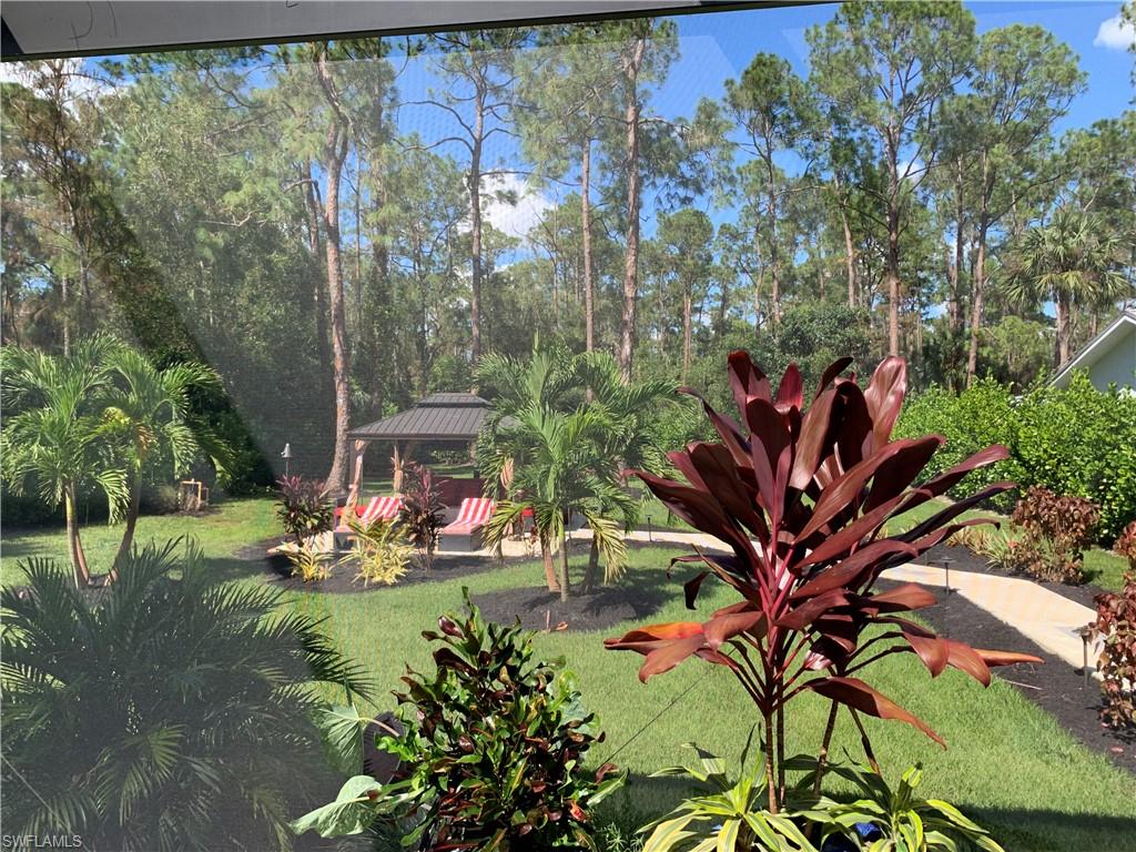 3651 29th Avenue Southwest Naples, FL 34117 - Photo 2 of 49 a view of a backyard with plants and a fountain