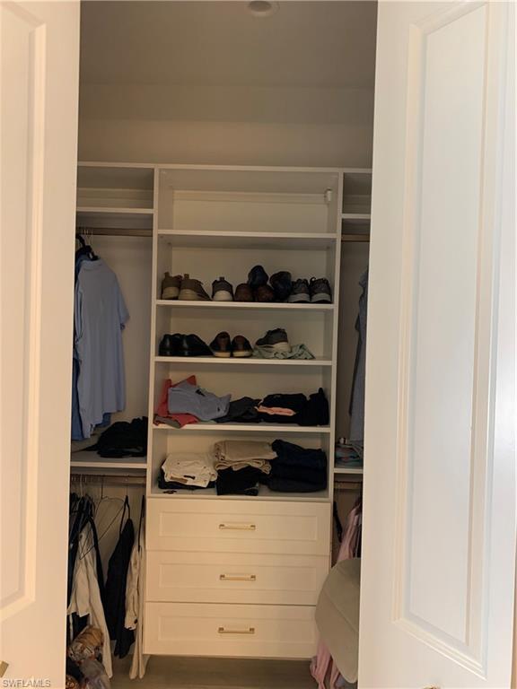 3651 29th Avenue Southwest Naples, FL 34117 - Photo 30 of 49 a view of walk in closet with clothes and shoes