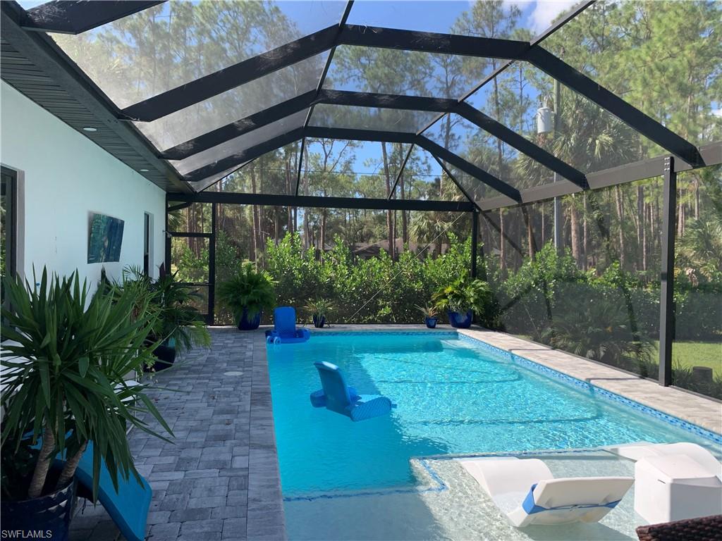 3651 29th Avenue Southwest Naples, FL 34117 - Photo 3 of 49 a backyard of a house with plants and outdoor seating