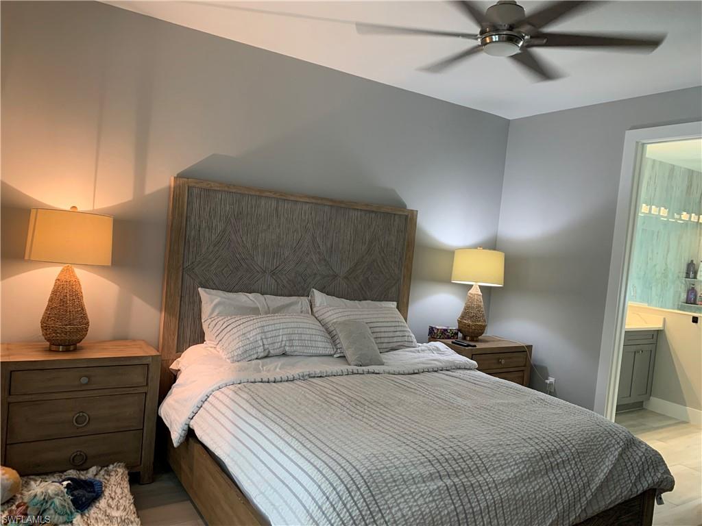 3651 29th Avenue Southwest Naples, FL 34117 - Photo 31 of 49 a bedroom with a bed and lamp