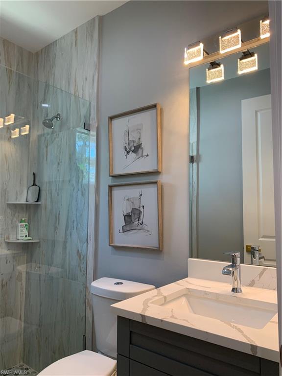 3651 29th Avenue Southwest Naples, FL 34117 - Photo 38 of 49 a bathroom with a sink a toilet and shower