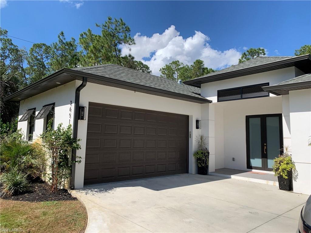 3651 29th Avenue Southwest Naples, FL 34117 - Photo 5 of 49 a front view of a house with a garage