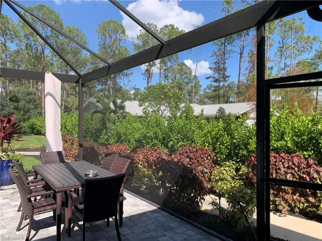 a view of a patio with table and chairs and potted plants