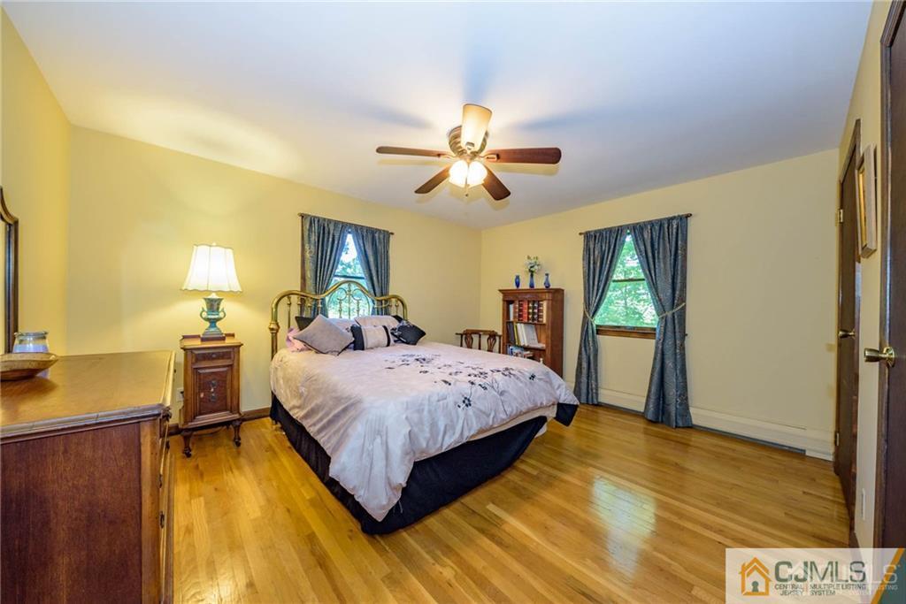 4 Tower Road Pompton Lakes, NJ 07442 - Photo 14 of 25 a spacious bedroom with a bed and a chandelier