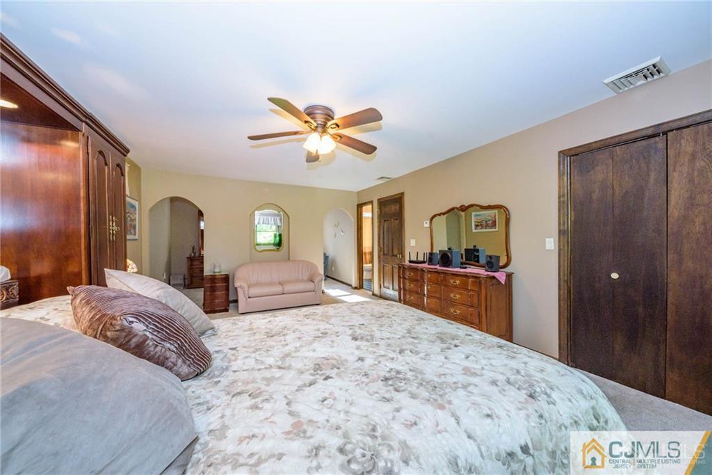 4 Tower Road Pompton Lakes, NJ 07442 - Photo 19 of 25 a bedroom with a bed and a dresser with mirror