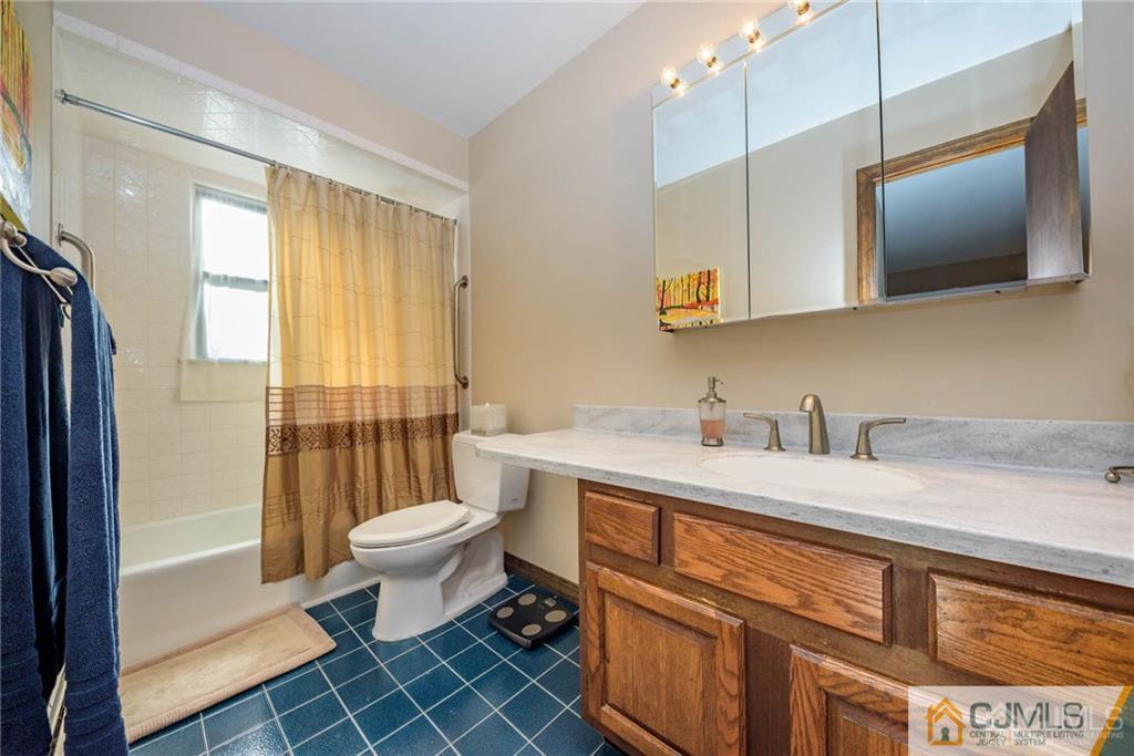 4 Tower Road Pompton Lakes, NJ 07442 - Photo 21 of 25 a bathroom with a sink a toilet and mirror