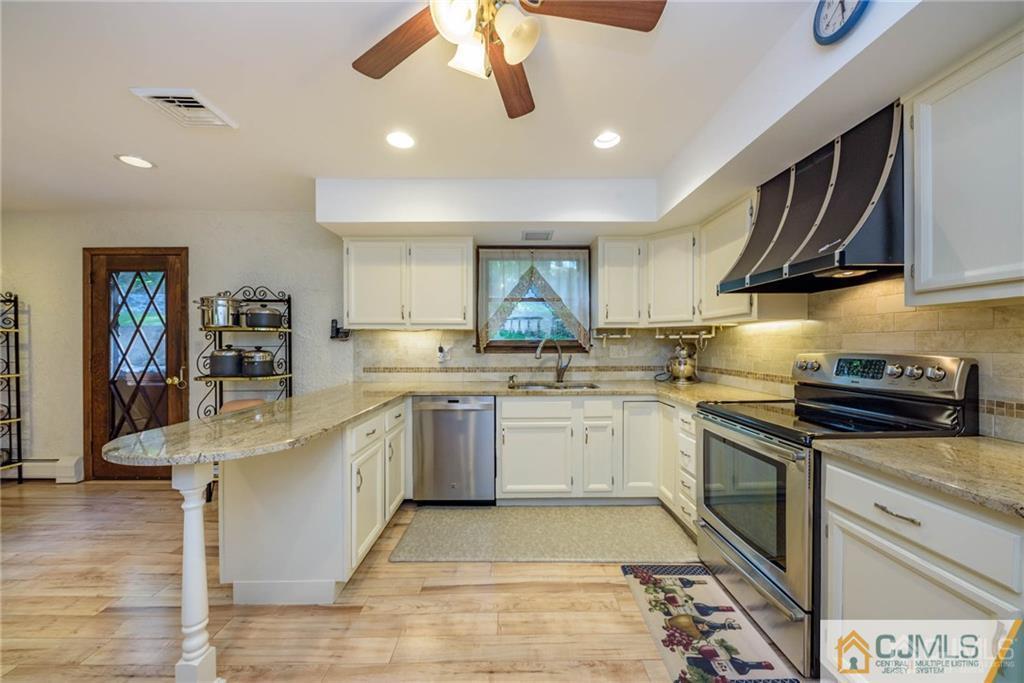 4 Tower Road Pompton Lakes, NJ 07442 - Photo 8 of 25 a kitchen with stainless steel appliances granite countertop a sink and stove