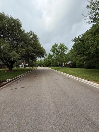a view of a road with a yard