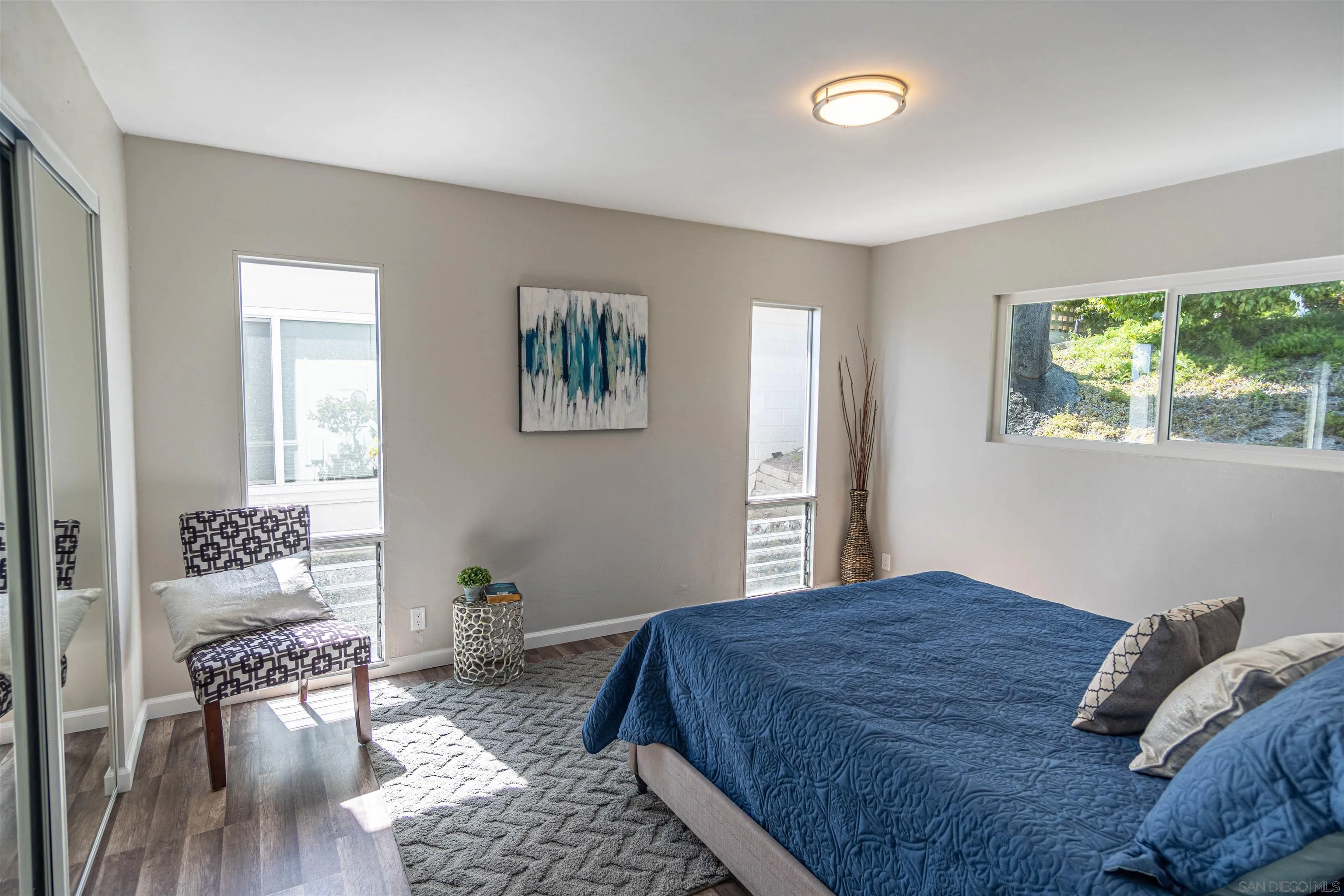 3747 Vista Campana South, Unit 43 Oceanside, CA 92057 - Photo 16 of 30 a bedroom with a bed and wooden floor