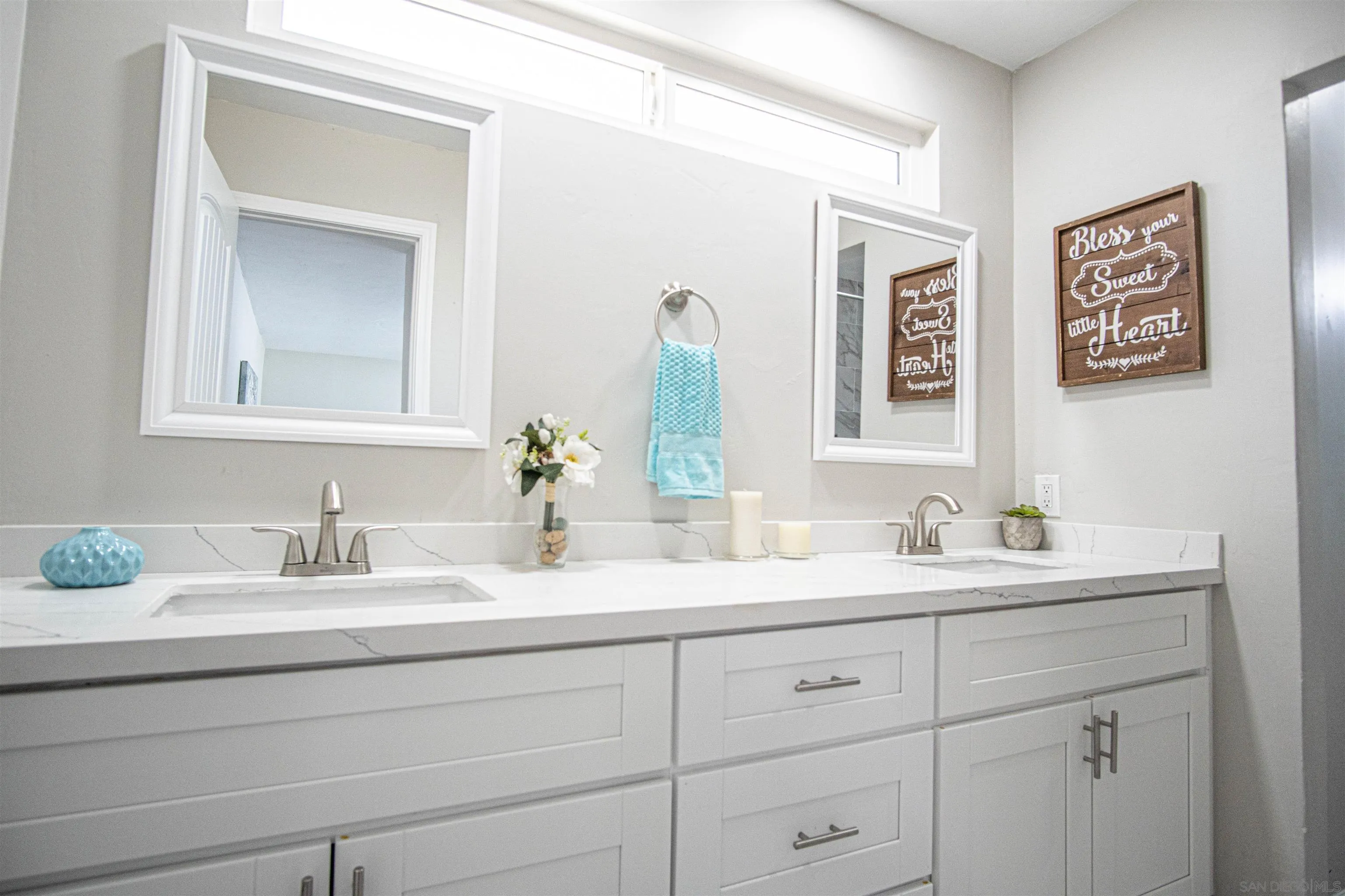3747 Vista Campana South, Unit 43 Oceanside, CA 92057 - Photo 20 of 30 a bathroom with double sink and a mirror