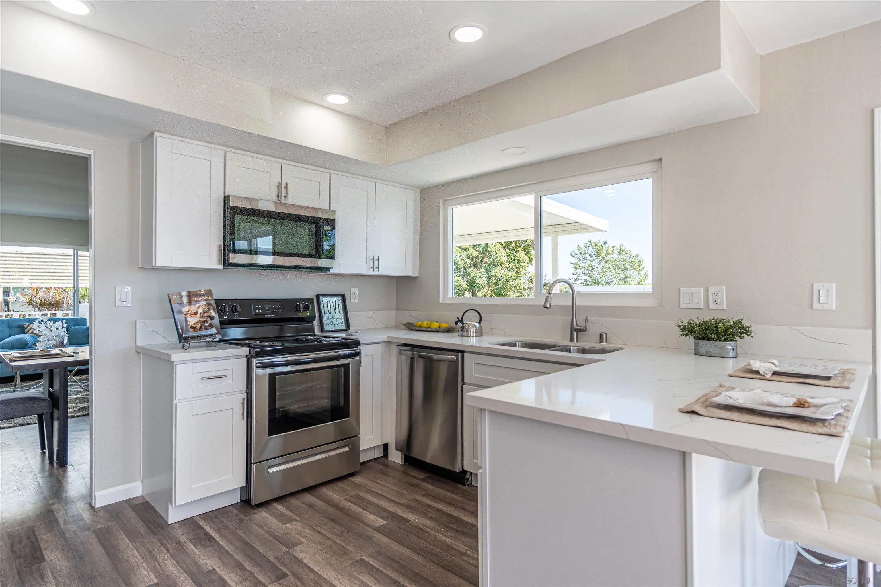 3747 Vista Campana South, Unit 43 Oceanside, CA 92057 - Photo 2 of 30 a kitchen with a stove a sink and a microwave