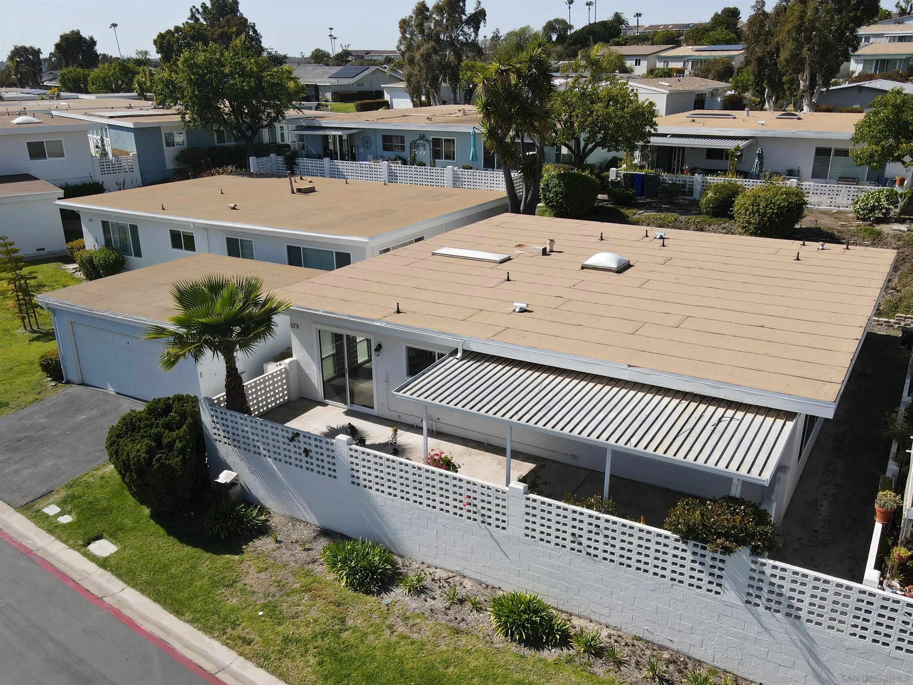 3747 Vista Campana South, Unit 43 Oceanside, CA 92057 - Photo 26 of 30 a view of a house with a patio and a yard