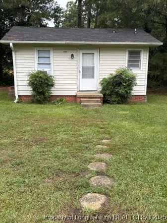 a front view of a house with garden