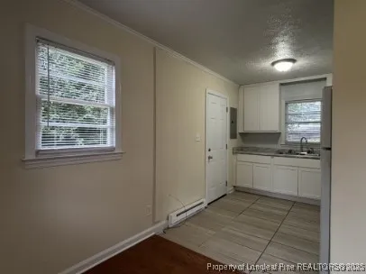 a kitchen with stainless steel appliances cabinets and window
