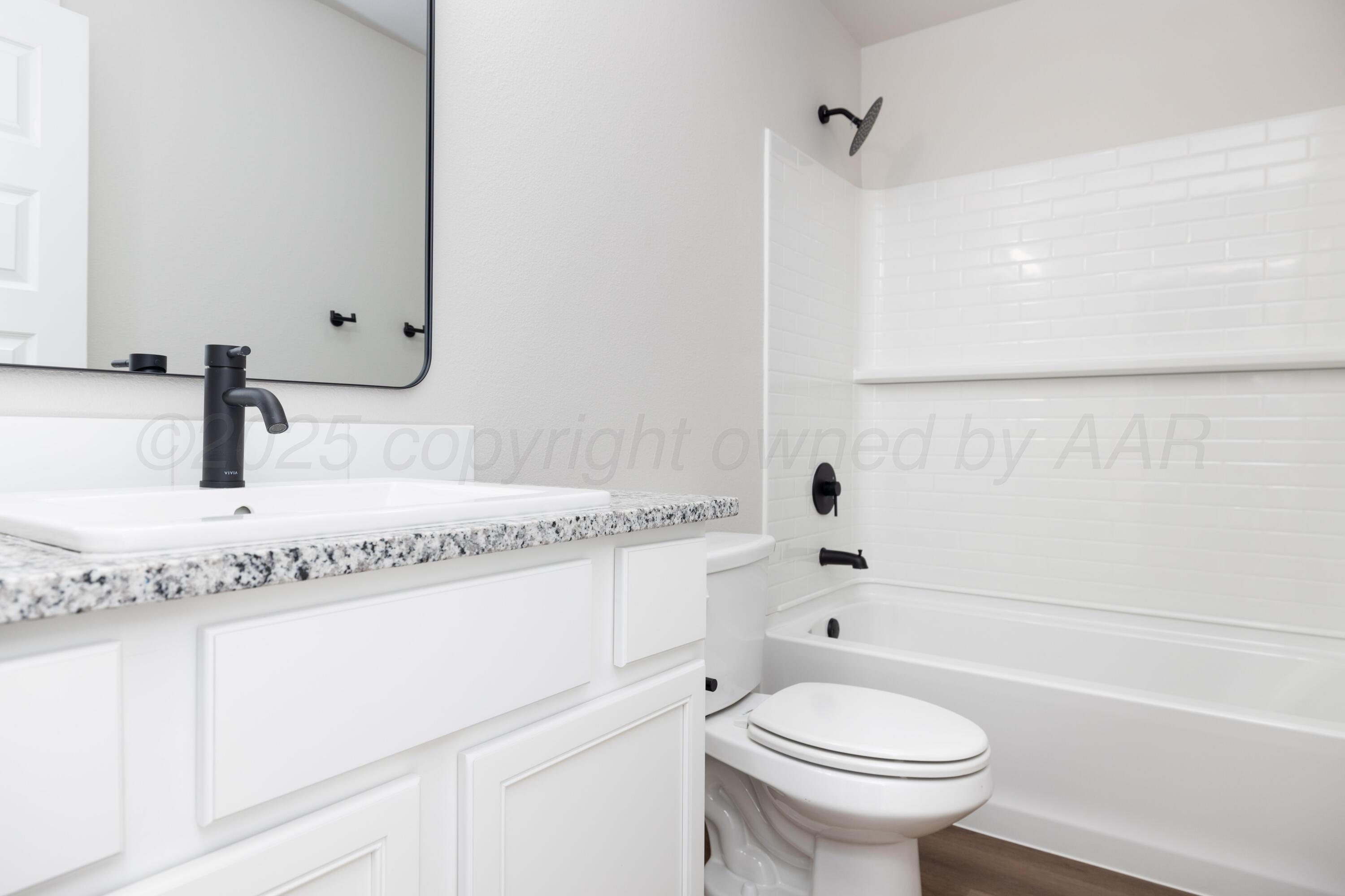 3004 Swenson Street Amarillo, TX 79124 - Photo 2 of 8 a bathroom with a sink a toilet and a bathtub