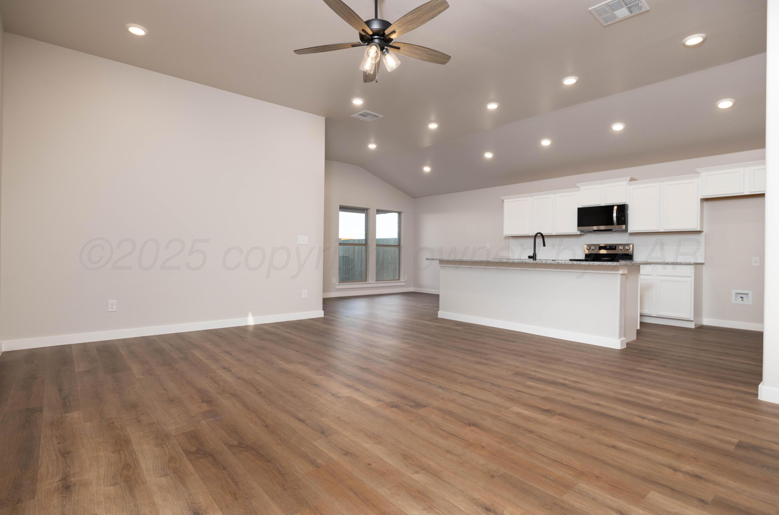 3004 Swenson Street Amarillo, TX 79124 - Photo 5 of 8 a view of a kitchen with a sink and a microwave