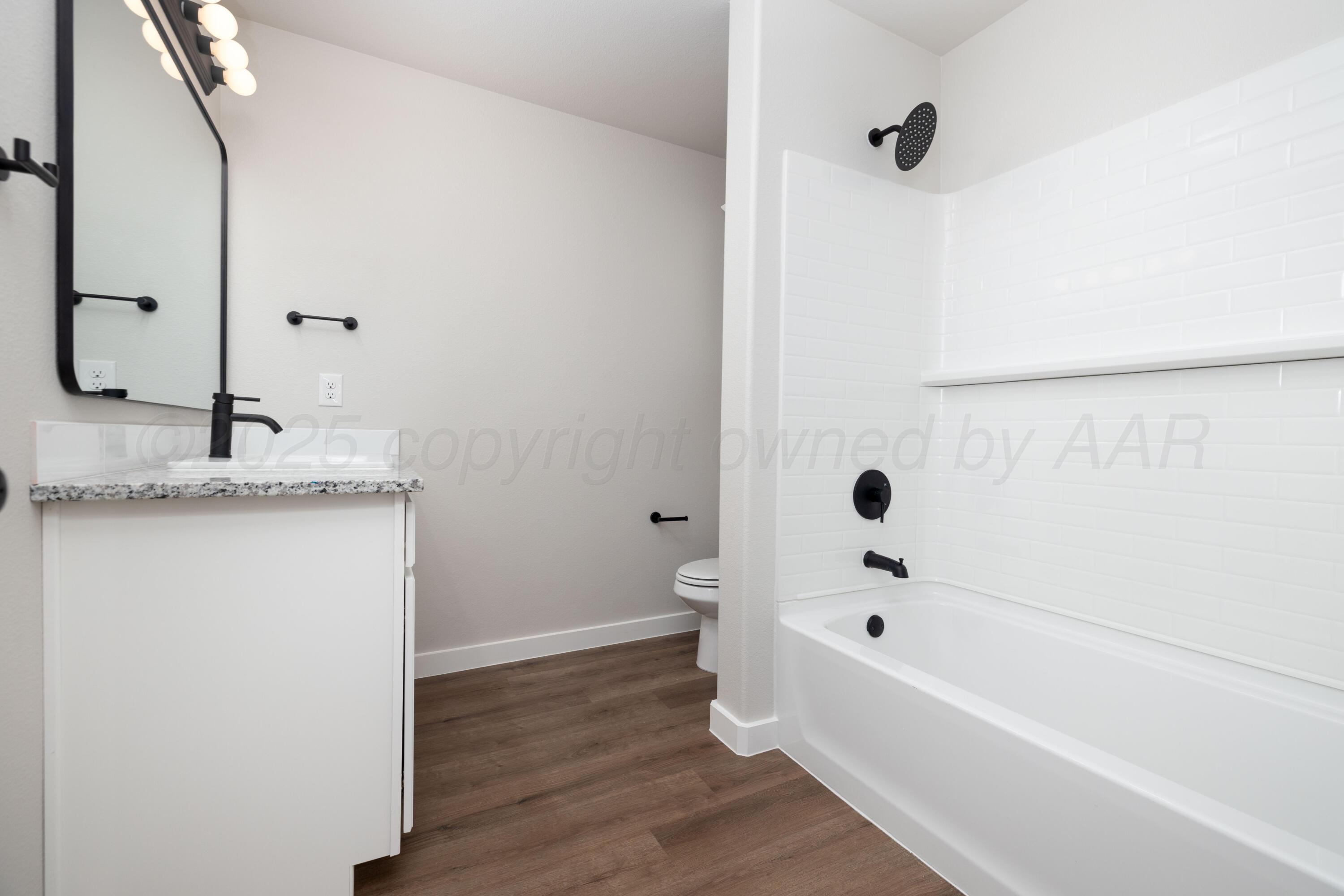 3004 Swenson Street Amarillo, TX 79124 - Photo 8 of 8 a bathroom with a granite countertop bathtub shower and sink