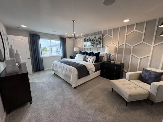 a spacious bedroom with a bed and window