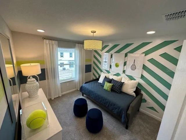 a living room with furniture and a lamp