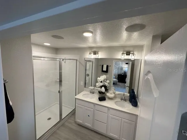 a bathroom with double sink and shower