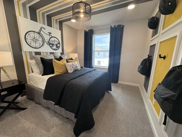 a bedroom with a bed and a chandelier