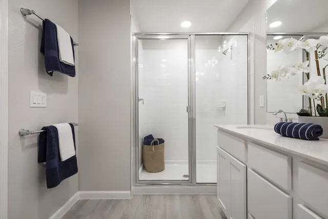 a bathroom with a shower and a sink
