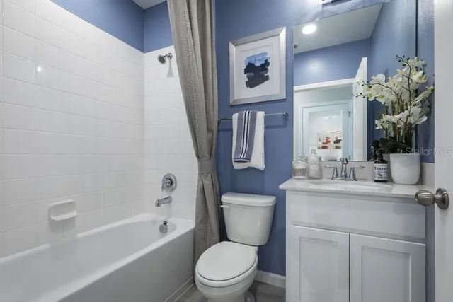 a bathroom with a toilet sink and shower