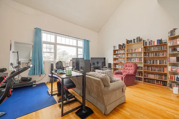 a living room with furniture and a book shelf