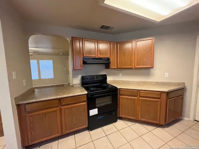 a kitchen with granite countertop cabinets and steel stainless steel appliances