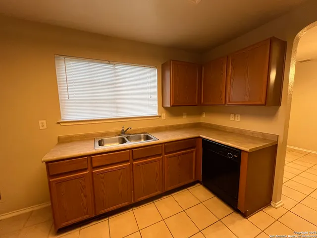 a kitchen with sink and cabinets