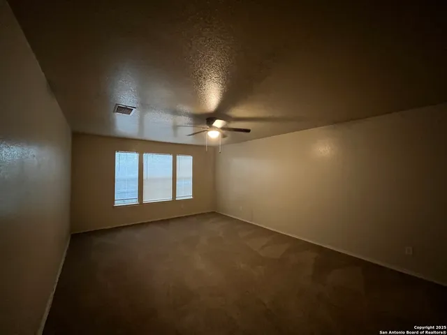 an empty room with a empty space and windows