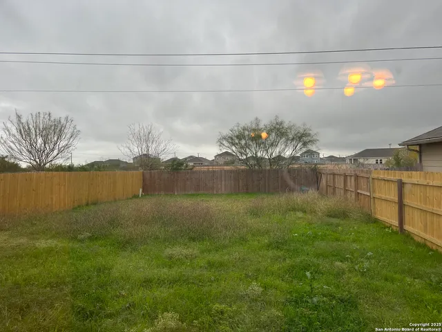 a view of lake with houses in background